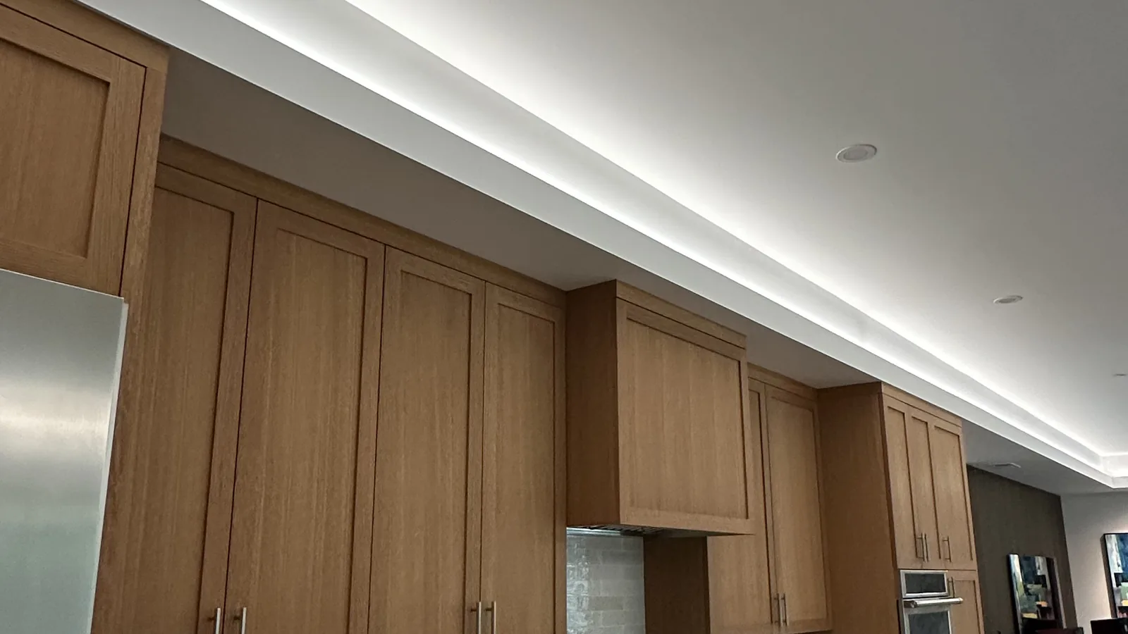 Continuous LED cove lighting and recessed downlights installed in a modern Sonoma County kitchen