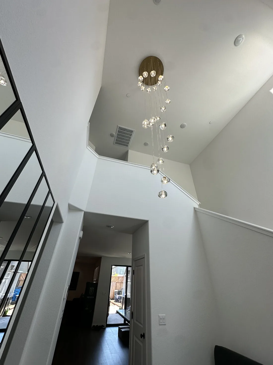 Cascading crystal chandelier installed in a two-story foyer in Sonoma County, CA