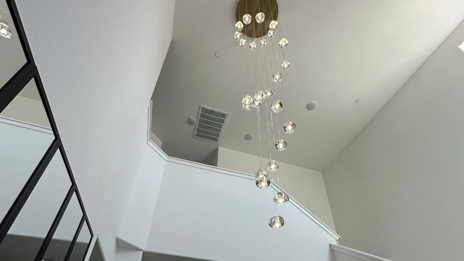 Cascading crystal chandelier installed in a two-story foyer in Sonoma County, CA