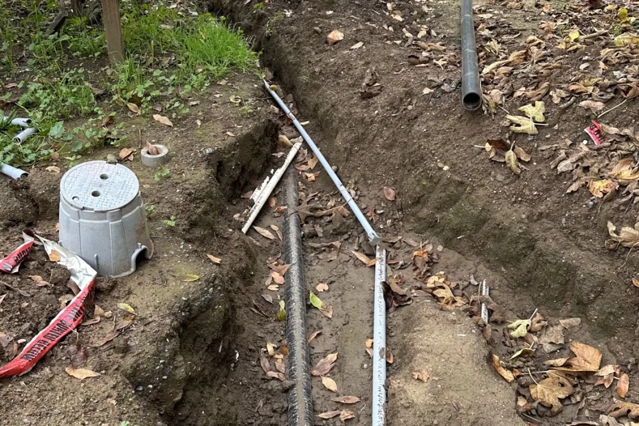 Open trench with conduit laid for an underground electrical feeder in Sonoma County, CA