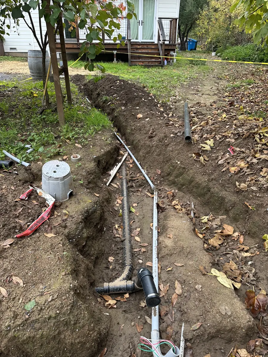 Open trench with conduit laid for an underground electrical feeder in Sonoma County, CA